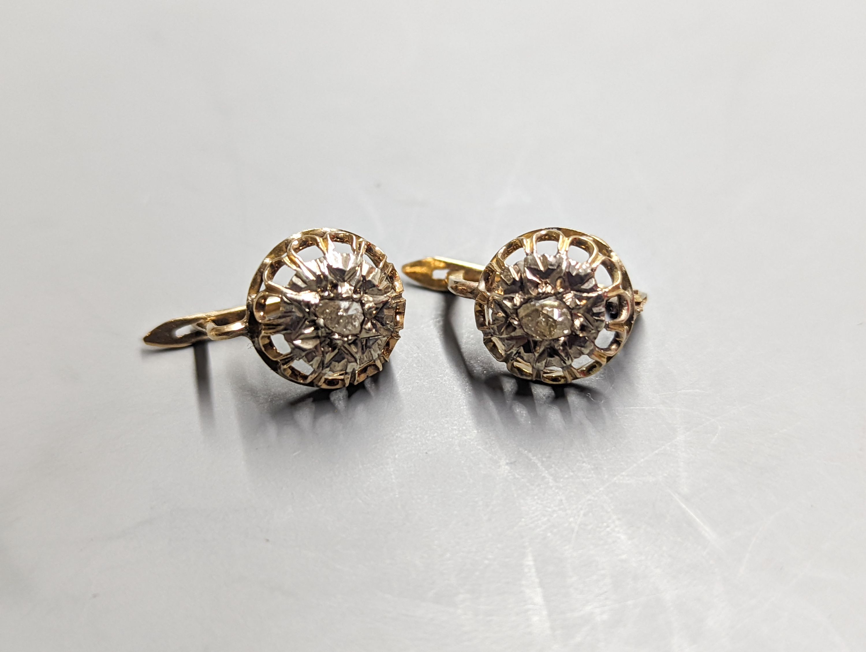 A pair of yellow metal and solitaire illusion set rose cut diamond earrings, 10mm and a 15ct, sapphire and diamond cluster set bar brooch, 66mm, gross weight 9.5 grams.